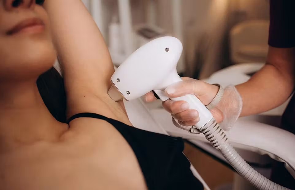 Physician performing laser hair removal on a patient's underarm
